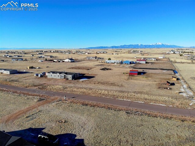 bird's eye view featuring a rural view and a mountain view