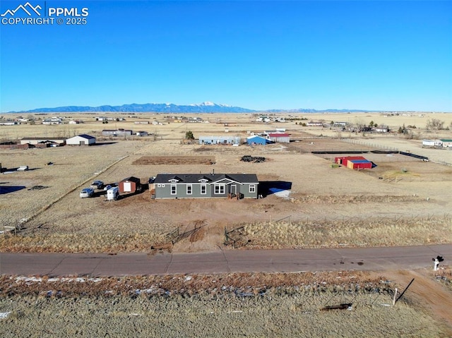 drone / aerial view featuring a rural view and a mountain view