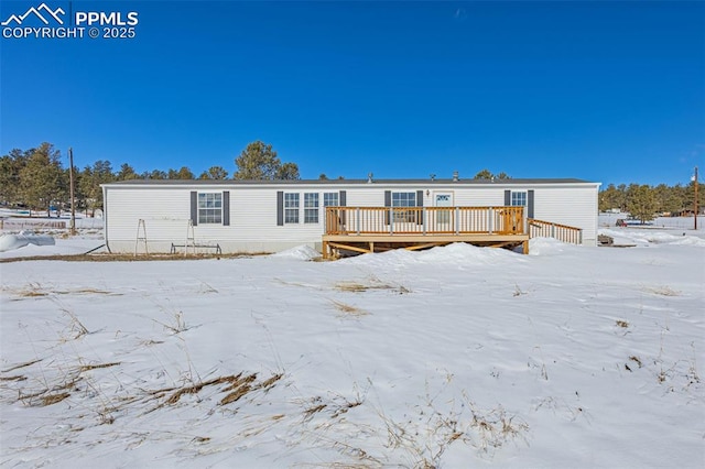 snow covered property featuring a wooden deck