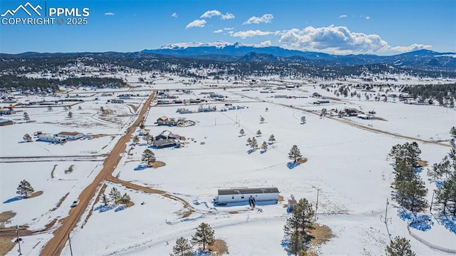 snowy aerial view with a mountain view