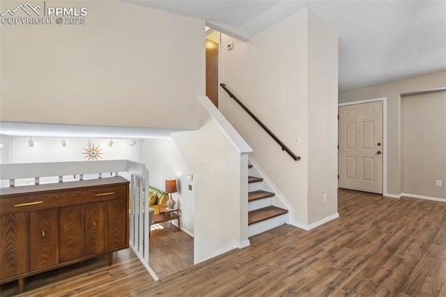 foyer with a textured ceiling and hardwood / wood-style floors