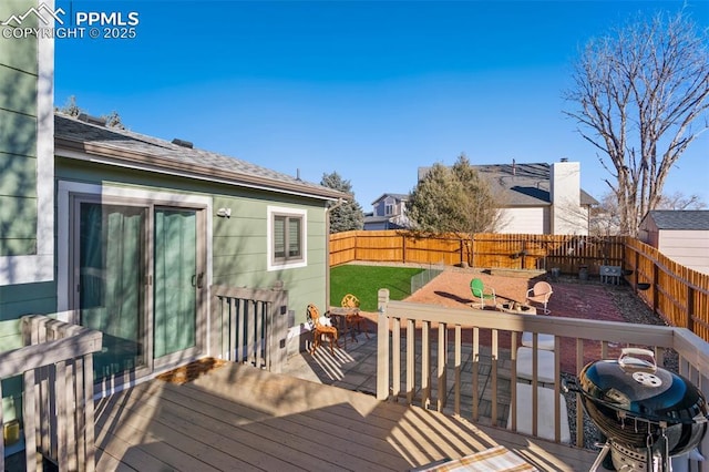 wooden deck featuring area for grilling