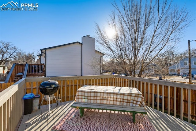 wooden deck featuring a grill