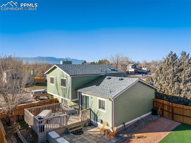 back of house featuring a patio area and a deck with mountain view