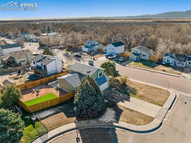 birds eye view of property with a mountain view