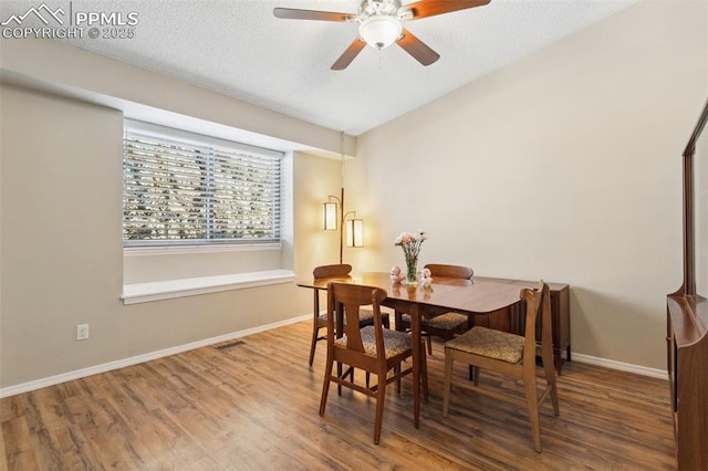 dining space featuring ceiling fan and wood-type flooring