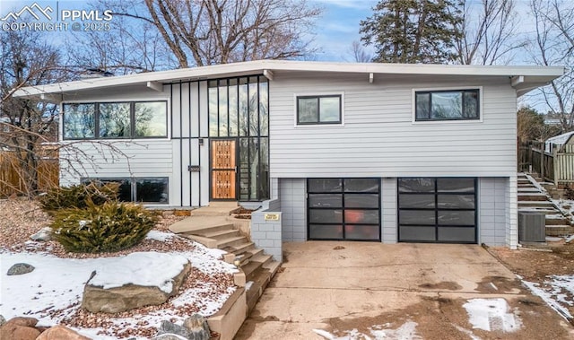 view of front of home featuring a garage and cooling unit