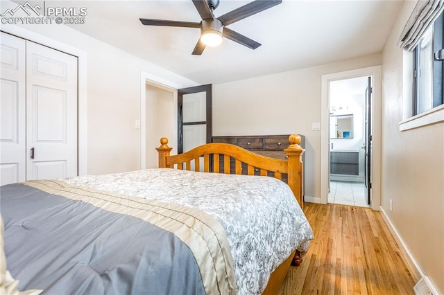 bedroom featuring a closet, ceiling fan, ensuite bathroom, and light hardwood / wood-style floors