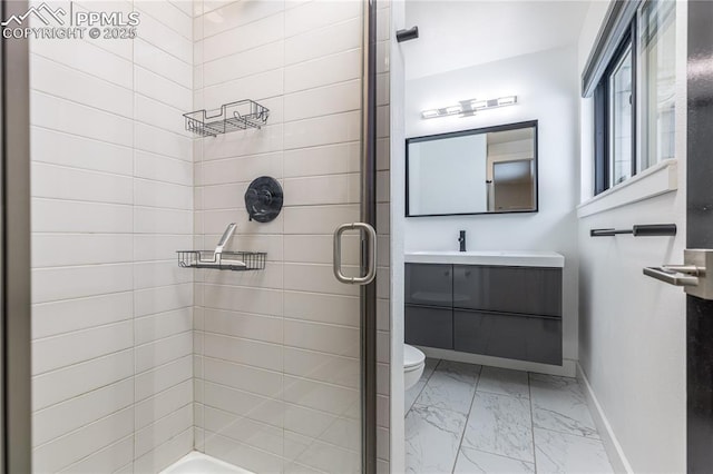 bathroom with an enclosed shower, vanity, and toilet