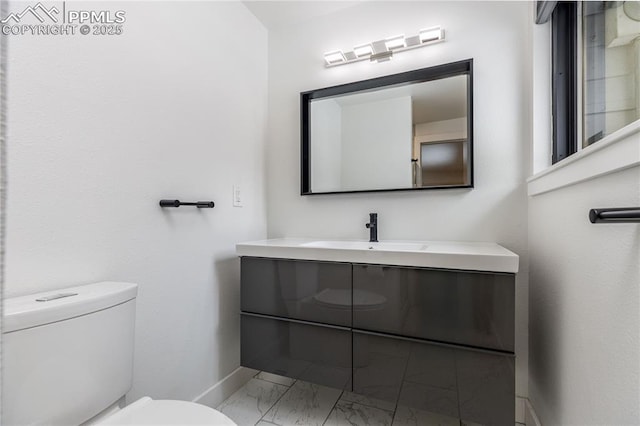 bathroom with toilet and vanity