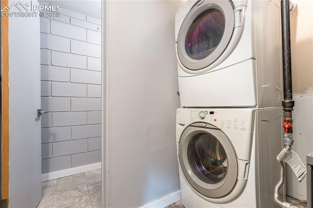 laundry area with stacked washer / dryer