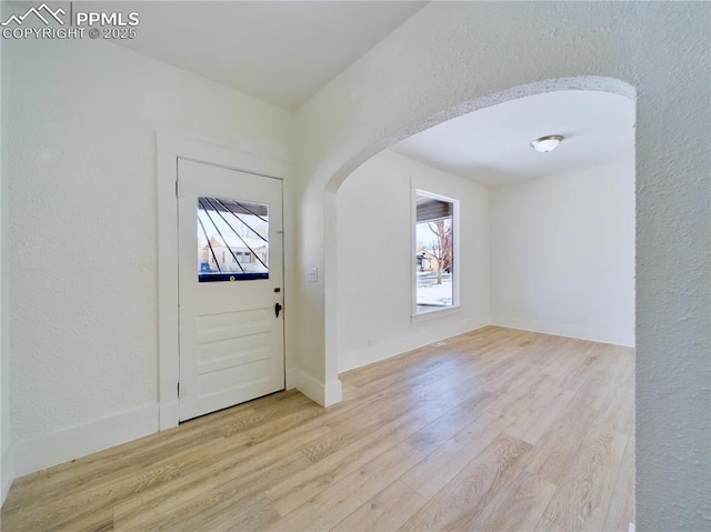 foyer entrance featuring a healthy amount of sunlight and light hardwood / wood-style flooring