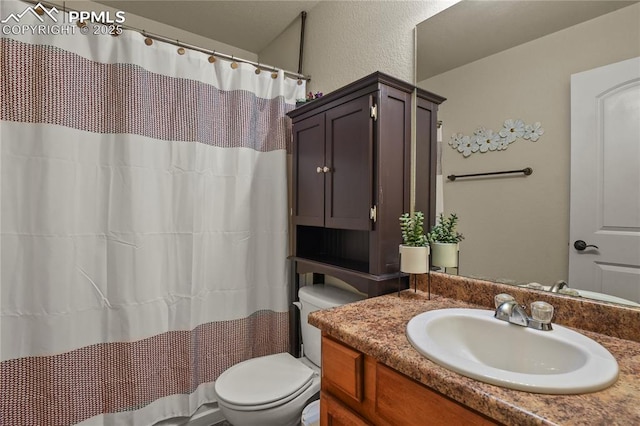 bathroom with toilet and vanity