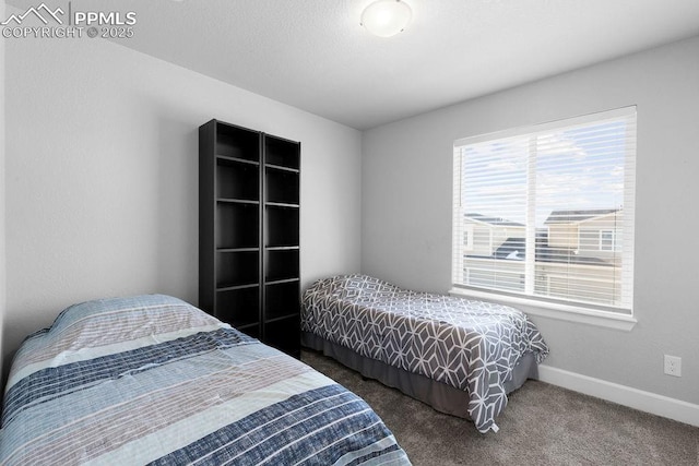 bedroom featuring dark colored carpet