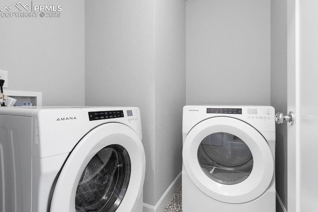 laundry area with washing machine and dryer and tile patterned flooring