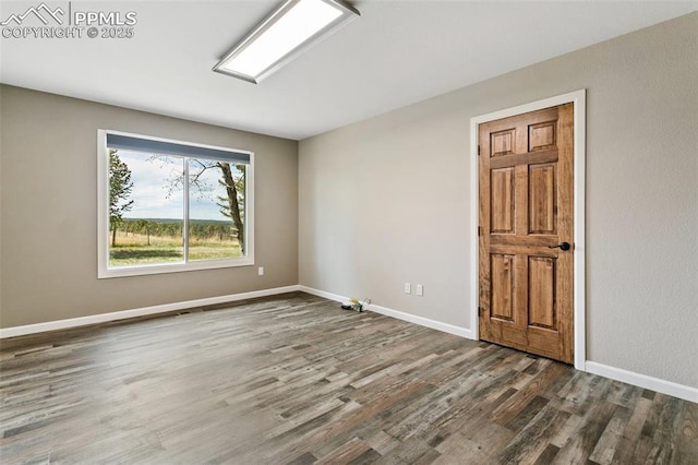 spare room featuring dark hardwood / wood-style flooring