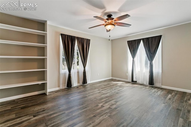 spare room featuring ceiling fan, a healthy amount of sunlight, and dark hardwood / wood-style flooring