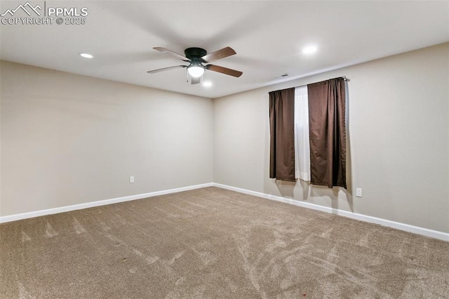 carpeted spare room with ceiling fan