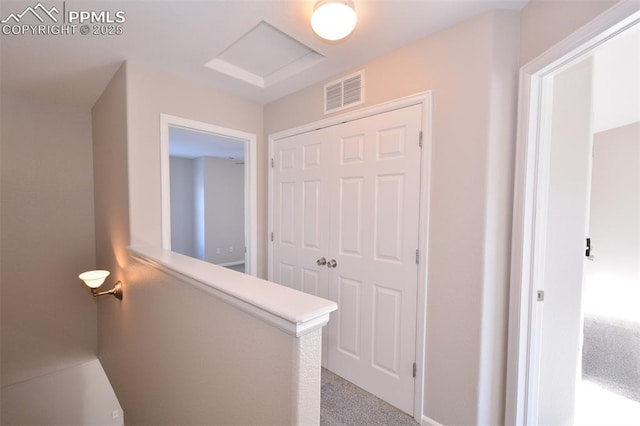 hallway featuring light colored carpet