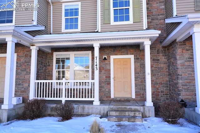 view of snow covered property entrance