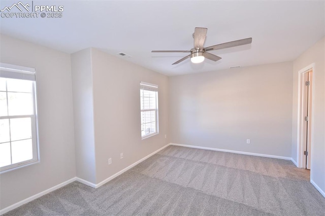 empty room with ceiling fan and light carpet