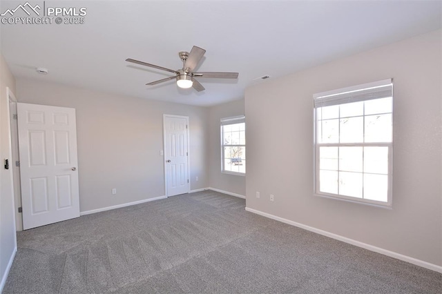 empty room featuring ceiling fan and carpet flooring