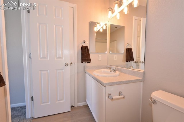 bathroom with toilet and vanity