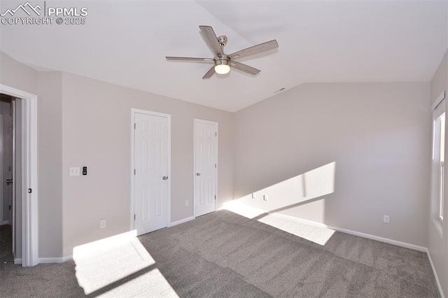 spare room with ceiling fan, carpet floors, and vaulted ceiling