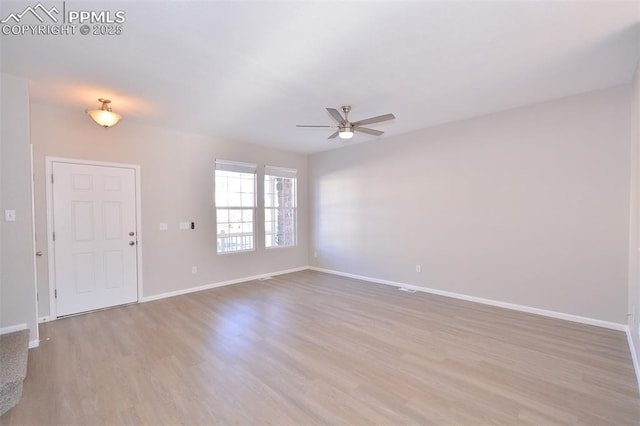 spare room featuring light wood-type flooring and ceiling fan