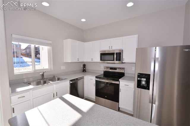 kitchen with white cabinets, appliances with stainless steel finishes, and sink