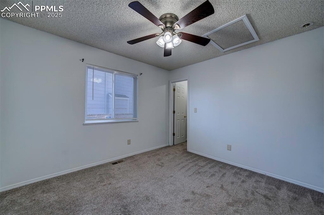 spare room featuring a textured ceiling and carpet flooring