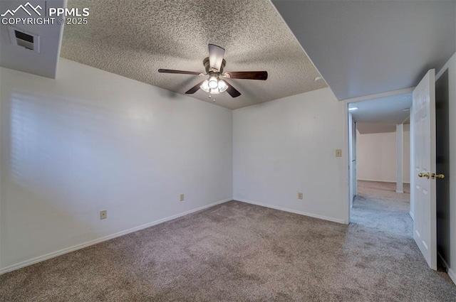 spare room featuring light carpet, ceiling fan, and a textured ceiling