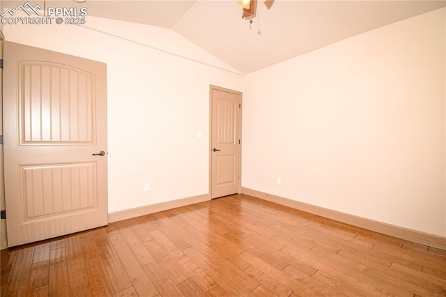 empty room featuring light hardwood / wood-style floors, lofted ceiling, and ceiling fan