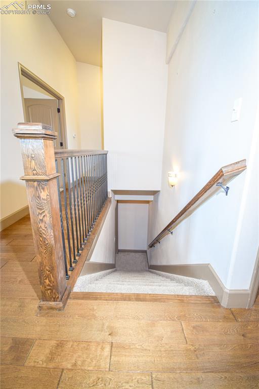 stairs featuring wood-type flooring