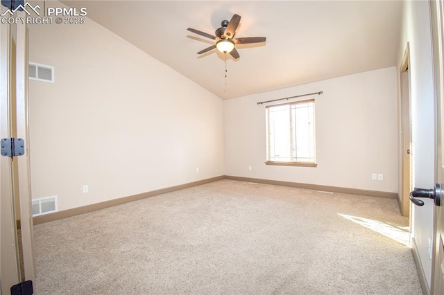 carpeted empty room with ceiling fan and vaulted ceiling