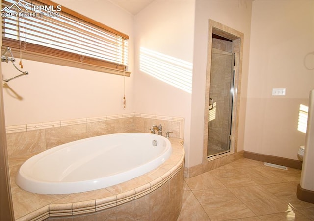 bathroom featuring toilet, tile patterned flooring, and plus walk in shower