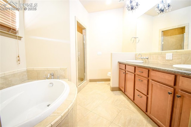 full bathroom featuring toilet, shower with separate bathtub, tile patterned floors, an inviting chandelier, and vanity