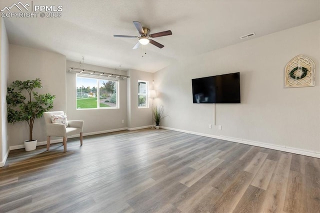 interior space with ceiling fan and hardwood / wood-style flooring