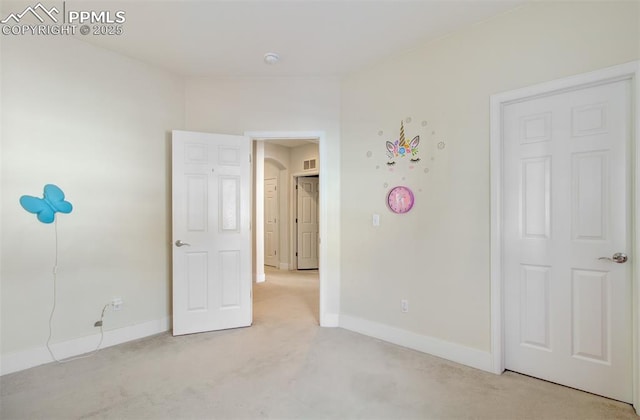 unfurnished bedroom featuring light carpet