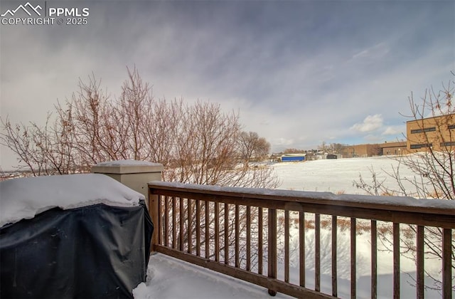 snow covered deck featuring grilling area