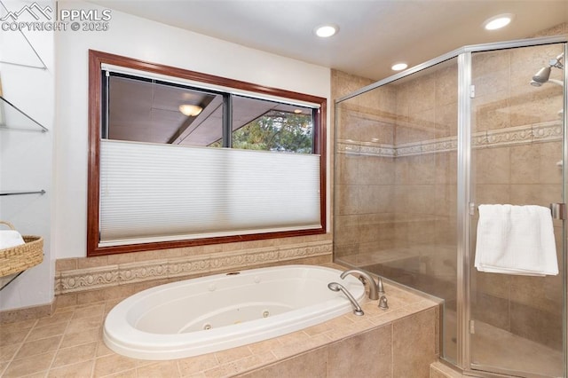 bathroom featuring tile patterned flooring and separate shower and tub