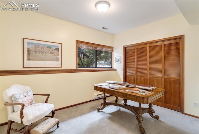 carpeted office space with a baseboard heating unit