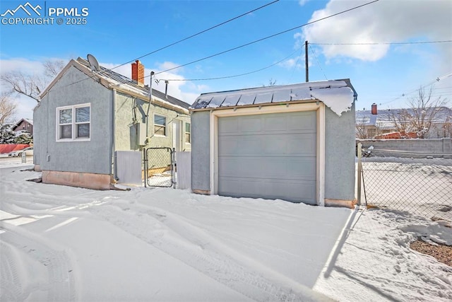 view of front of home with a garage and an outbuilding