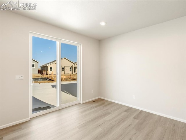 unfurnished room with light hardwood / wood-style floors