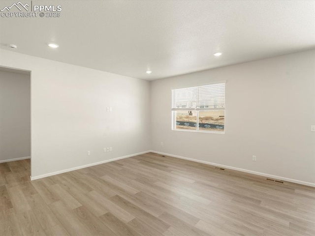 spare room with light wood-type flooring