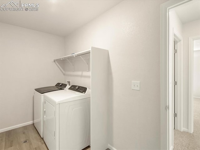 washroom with washer and dryer and light hardwood / wood-style floors