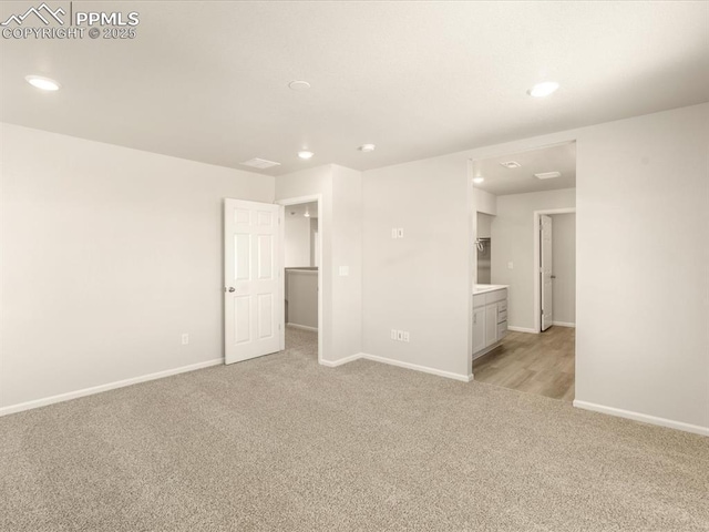 spare room featuring light colored carpet