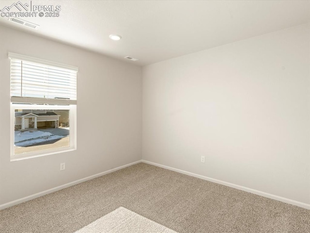 unfurnished room featuring carpet