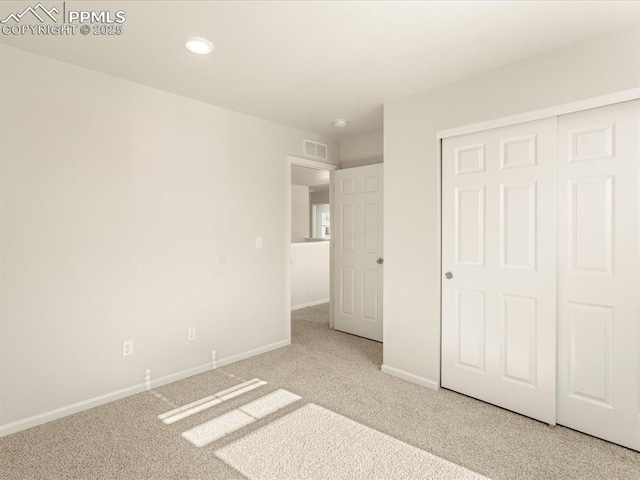 unfurnished bedroom featuring carpet and a closet