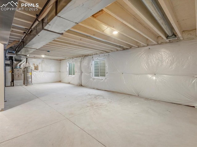 basement with electric water heater and heating unit